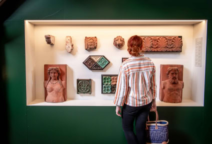 A woman is looking at the bricks at Cathrinesminde Brickworks.