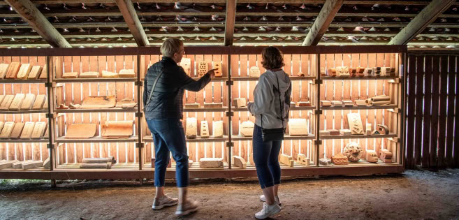 At Cathrinesminde Brickworks, two women are observing the historic bricks