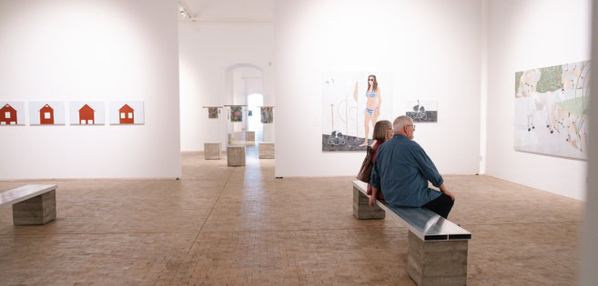 Ein Ehepaar sitzt auf einer Bank und betrachtet der Kunst im Kunstmuseum Tondern