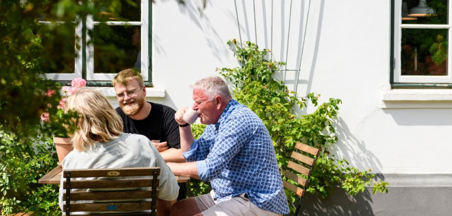 A family is enjoying coffee in the mill garden