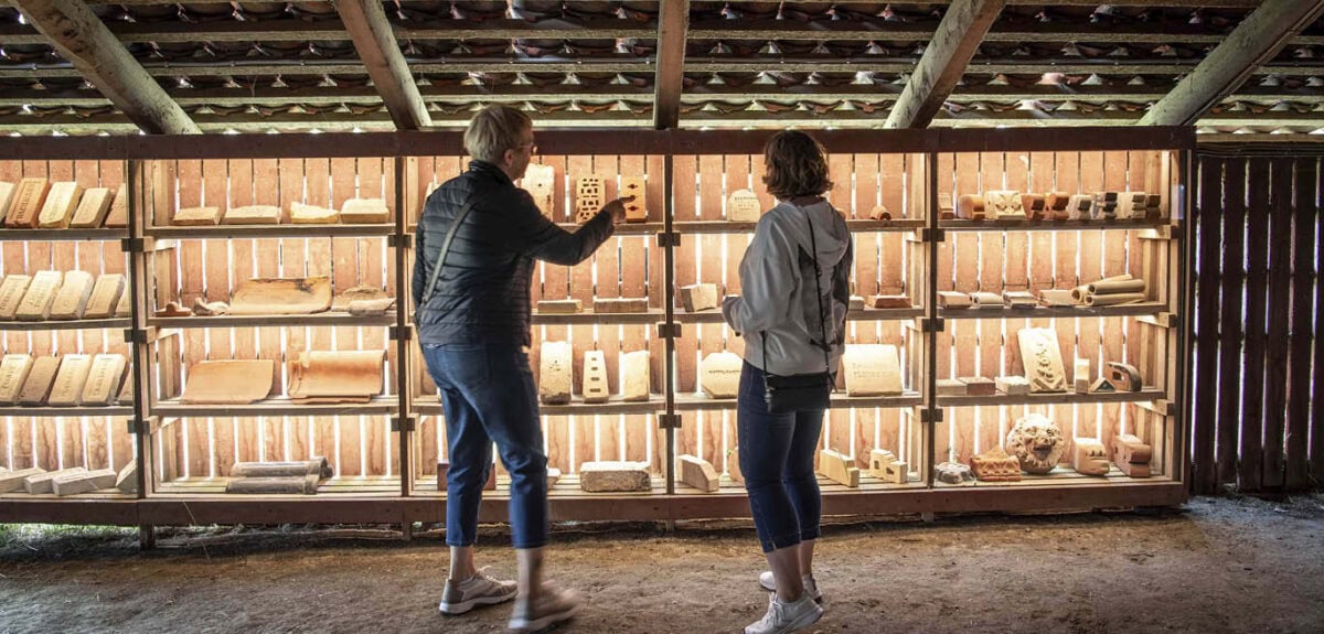 To kvinder kigger på teglsten udstilling på Cathrinesminde Teglværk.